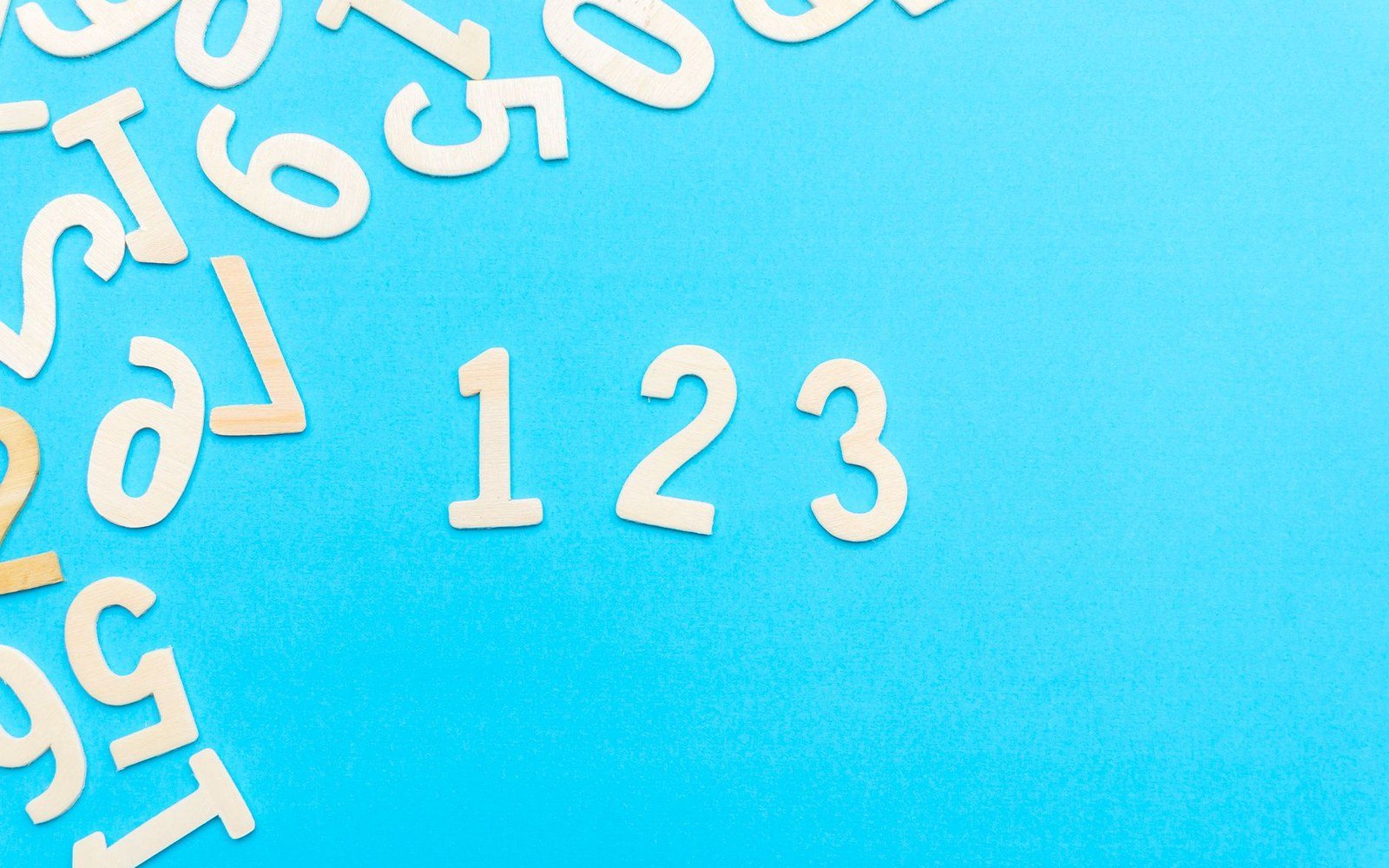 Large ultramarine numeral — 1,000,000 — set at 120px against bone ground with a 2px ink dimension rule beneath it and acid tick terminators at each end